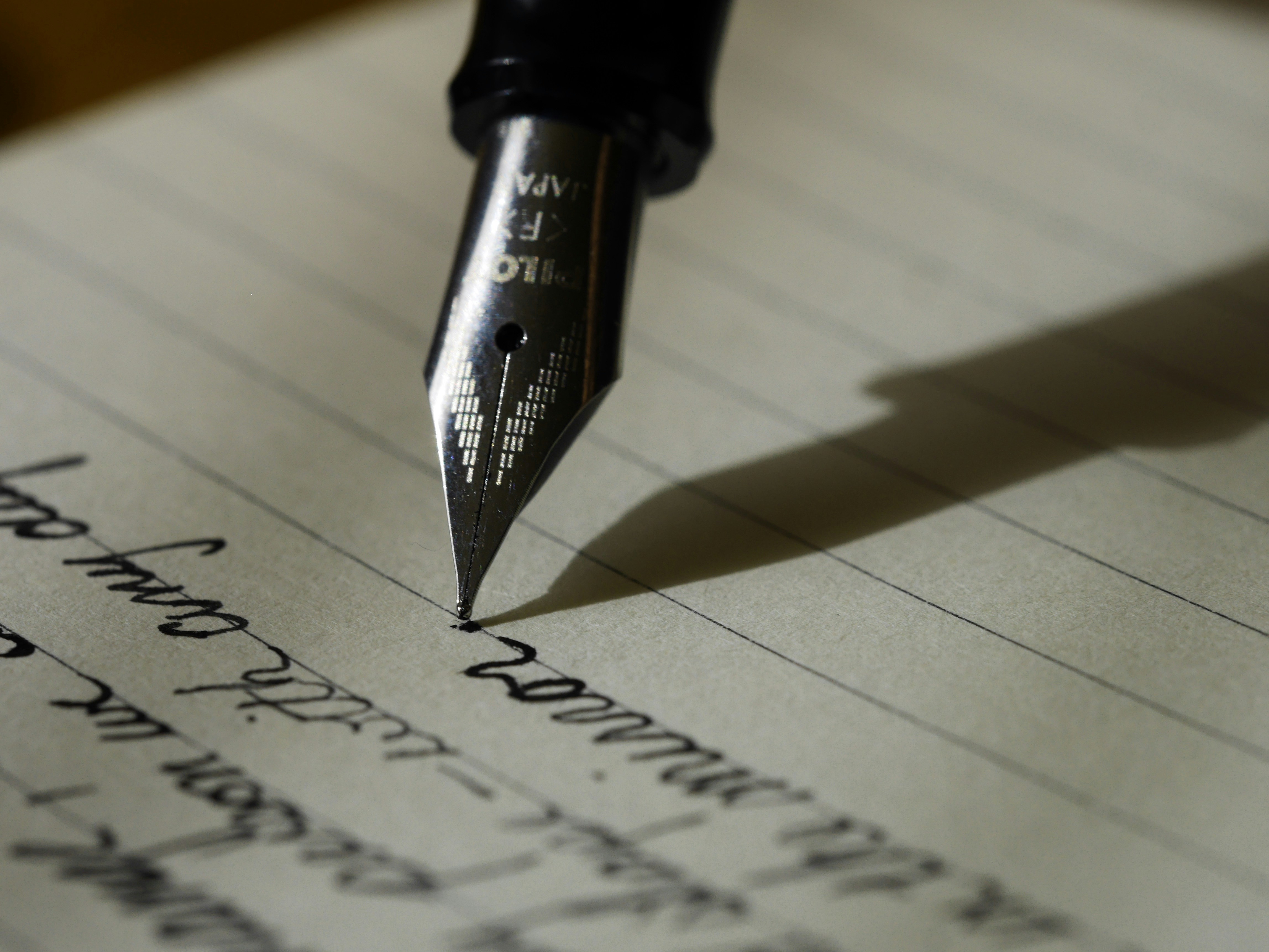 Calligraphy pen writing on paper